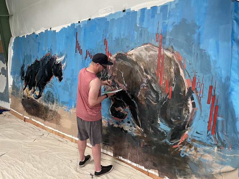 Photos of the artist creating "Bull vs. Bear" 3