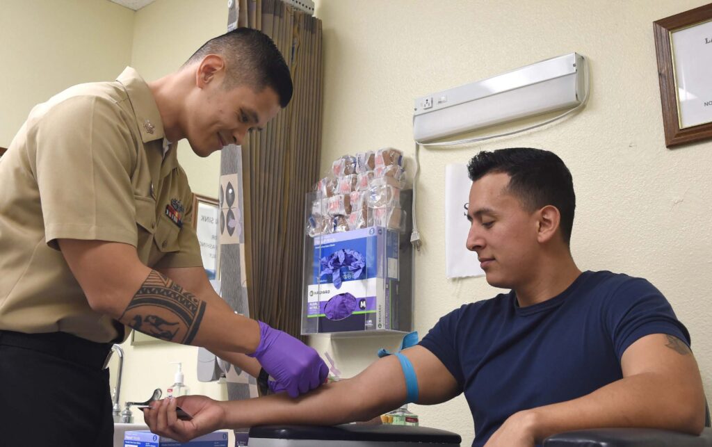 clinical chemistry student at The Citadel drawing blood