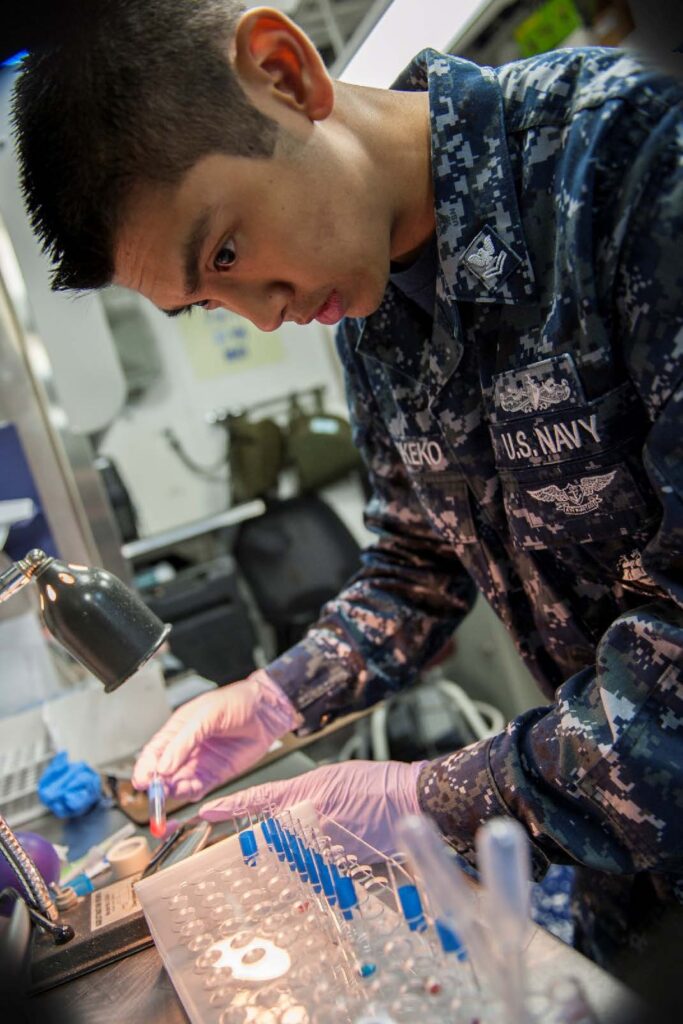 clinical chemistry student using test tubes