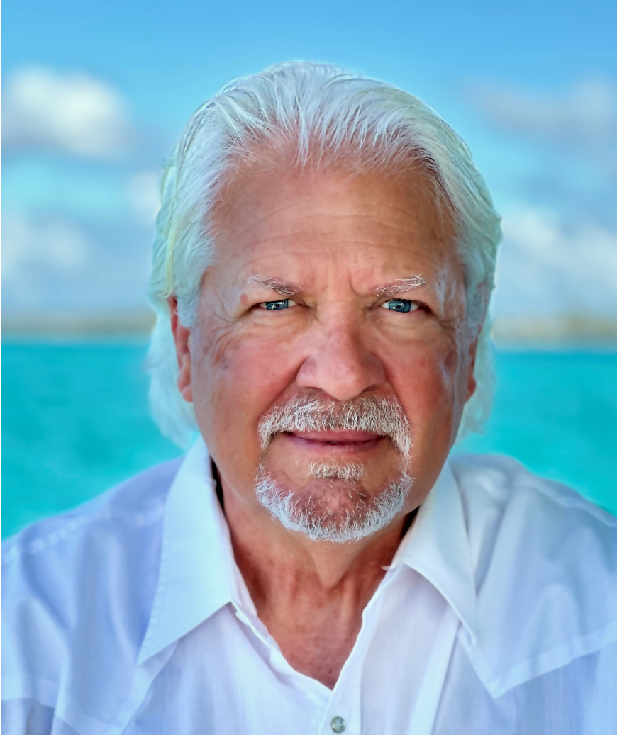 Close-up of Steven Roll, wearing a white shirt, with a bright blue background.