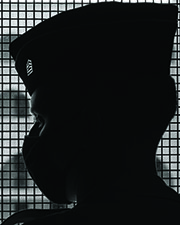 Photograph of cadet in doorway in barracks.