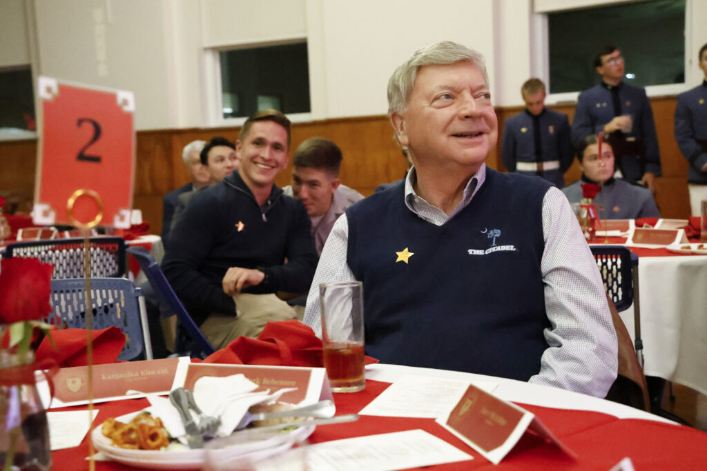 Ken Galsgaard and a guest smiling at their table.