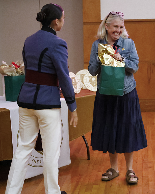 Kajanika Kincaid gives a raffle prize to an attendee.