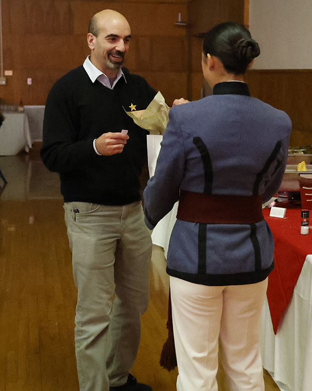 Kajanika Kincaid gives a raffle prize to Alex Fox.