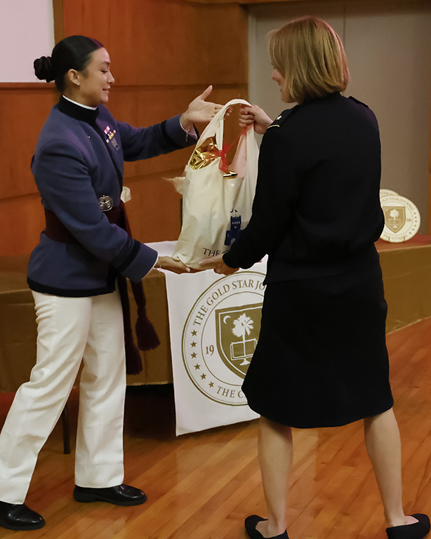 Kanjanika Kincaid gives a raffle prize to Dr. Sally Selden, Provost of The Citadel