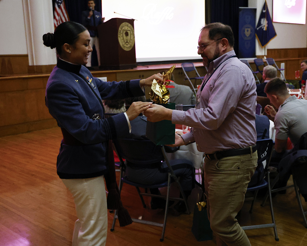 Kajanika Kincaid gives a raffle prize to a Citadel foundation member.