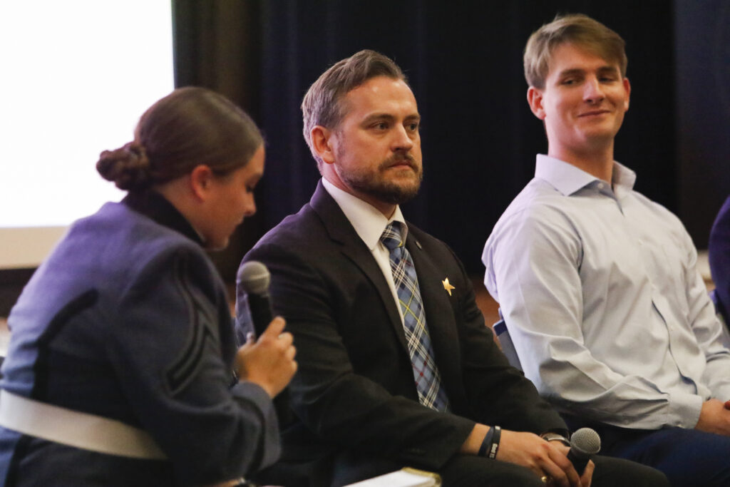 Proctor Kaitlyn Hatchew, (Editor), asking panelists Eric Zink '99 and Gage Timberlake '25 questions.