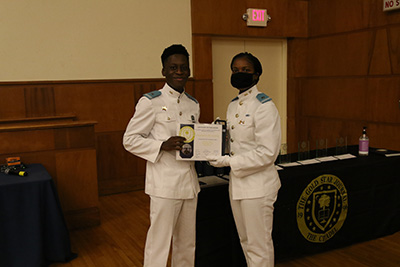 Taylor Diggs presenting the Dashawn Costley with his Certificate of Publication.