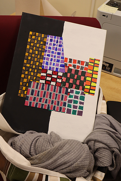 An unacceptable submission. the artwork is crooked and propped on a visible object.
