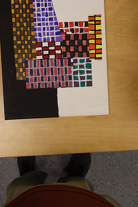 an example of an unacceptable submission. The photographers feet are visible and the artwork is not centered.