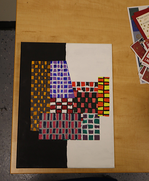 An unacceptable submission. The artwork is not cropped or centered, you can see the background, and there are objects in the background.
