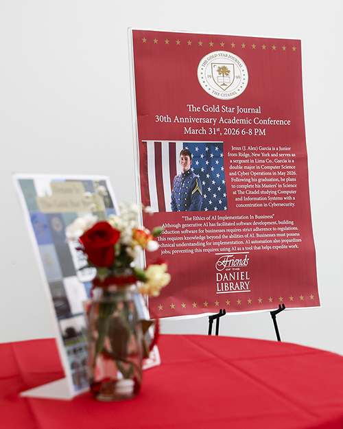 Flowers in vase, a poster is in the background