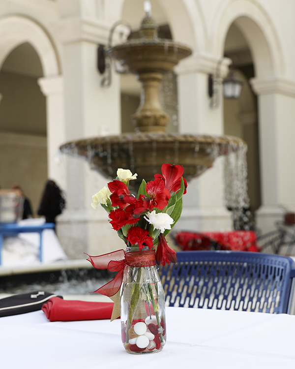 flowers in a vase in front of a fountain