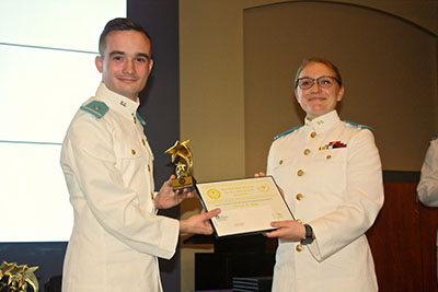 Sierra Morris presenting the Best Undergraduate Paper Award to William Hope.