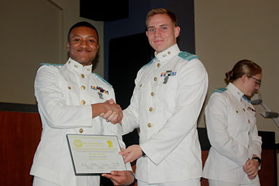 Carleton Bailiff III presenting Morgan Meredith with his Certificate of Publication.