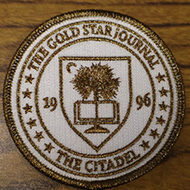 2026 Gold Star Journal uniform patch. It is white and gold