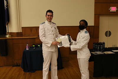 Taylor Diggs presenting the Jacob Williams with his Certificate of Publication.
