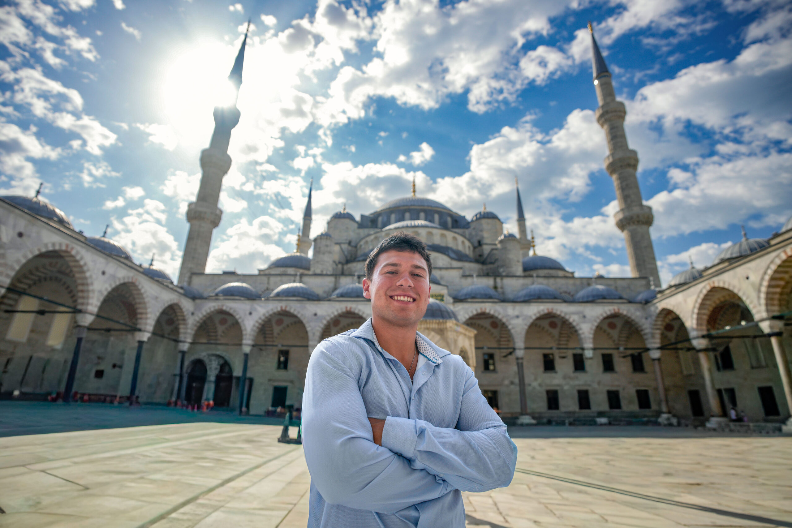 Cadet Gavin O'Brien stands with arms crossed in the courtyard of the Blue Mosque in Istanbul, Turkey.