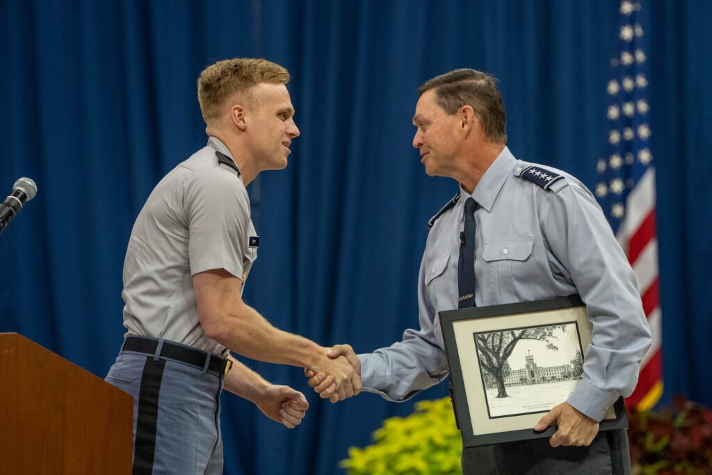 cadet shaking the hand of a professor