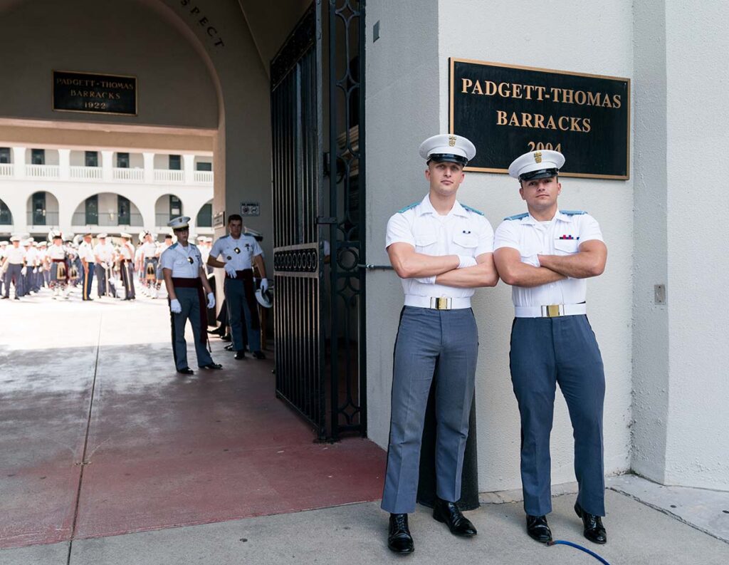 A picture of two male cadets in uniform in front of Padgett-Thomas barracks.