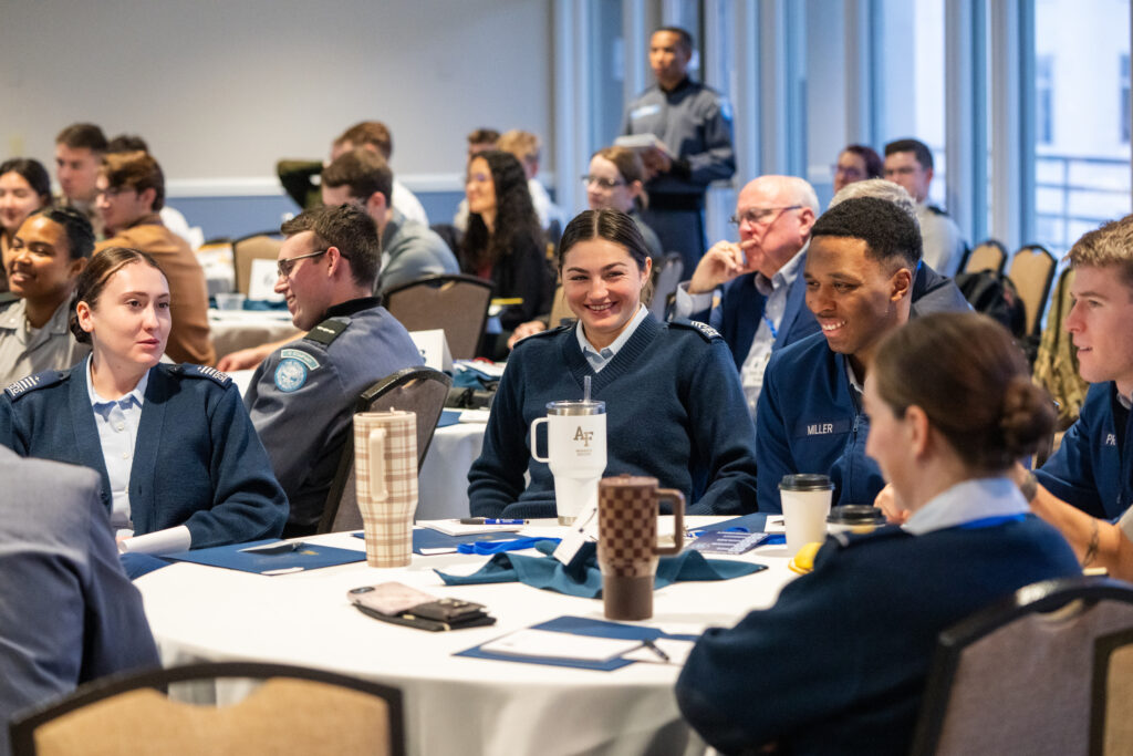Cadets and military academy students talk around a table during The Citadel’s Honor Conference.