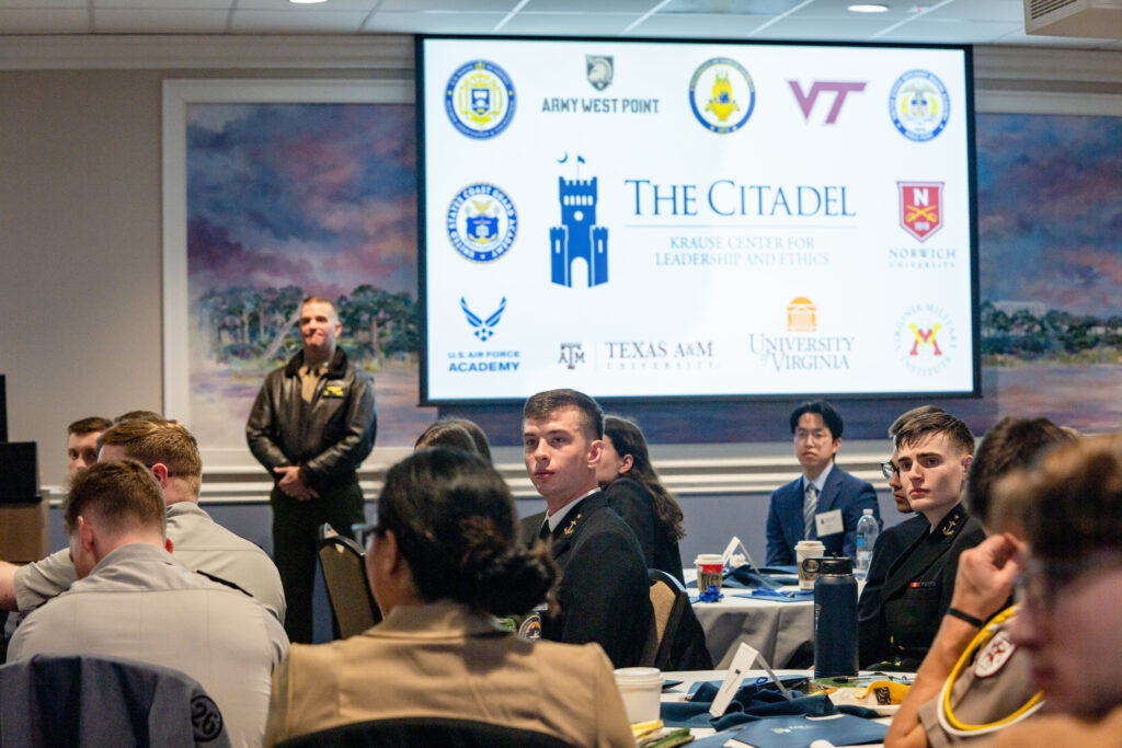 Cadets and military academy students attend The Citadel’s Honor Conference, with participating institutions displayed on a screen.