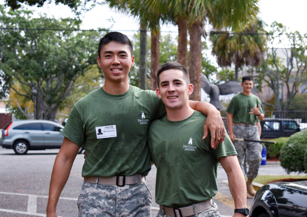 Two Citadel cadets pose together during an outdoor community service project.