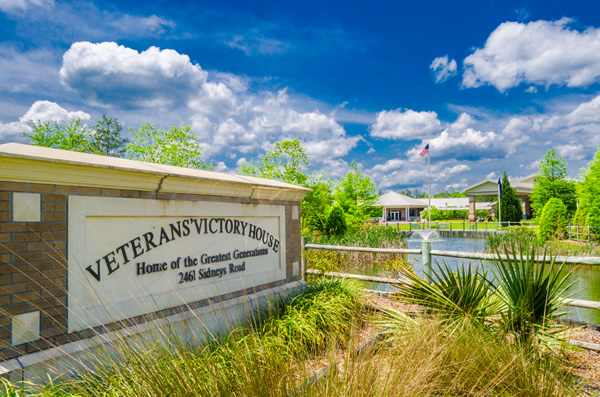 Veterans Victory House exterior with a sign reading “Home of the Greatest Generations.”