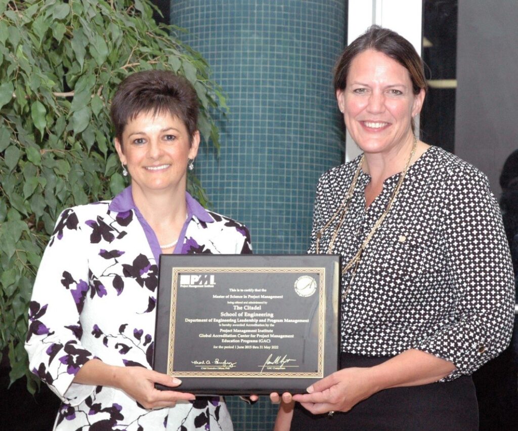 Dr. Tracey Richards presenting the MSPM accreditation plaque to Dr. Connie Book