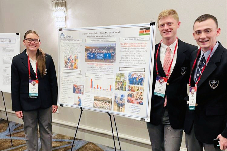Cadets McKenna Magin, Banks Scarpa, and Dylan Horne stand beside their South Carolina Theta poster presentation at the Alpha Epsilon Delta Centennial National Convention in Birmingham, Alabama.