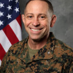 Col. Timothy Dremann, photographed in The Citadel photography studio with a United States flag backdrop.