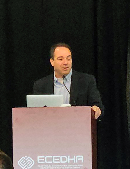 Mark McKinney, Ph.D., speaks at a podium during the Electrical and Computer Engineering Department Heads Association annual conference, with attendees seated in the foreground.