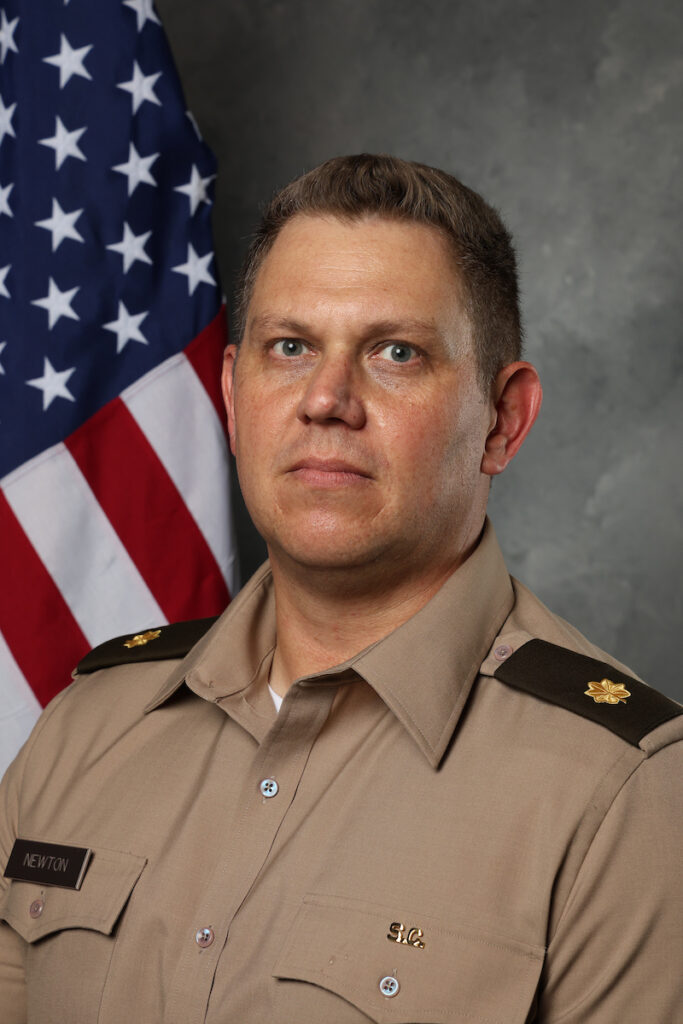 Mark Newton, Ph.D., Hope LaFreniere, Ph.D., photographed in The Citadel photography studio with a United States flag backdrop.