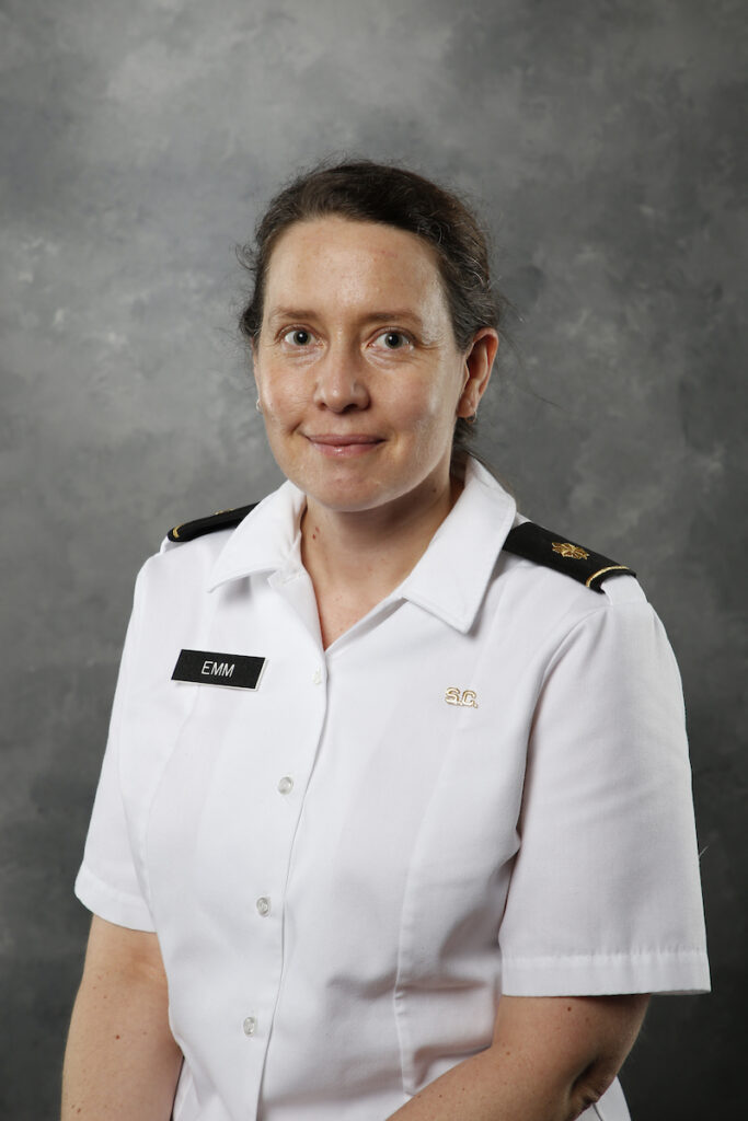 Professional portrait of Amy Emm, Ph.D., on a gray background.