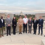 Citadel students standing on a balcony in Washington, D.C., with the capitol in the background.